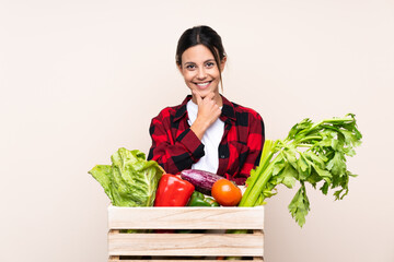 Farmer Woman holding fresh vegetables in a wooden basket laughing