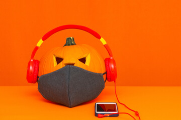 Happy Halloween decorations concept background.Mix variety candle items face mask and pumpkin listening music