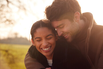 Head And Shoulders Of Loving Young Couple Walking Through Winter Countryside Together