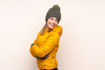 Woman with winter hat over isolated background laughing