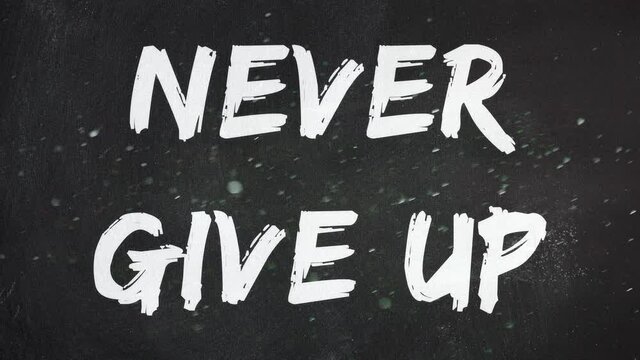 Real white dust floating in the air, in front of a blackboard with the words Never Give Up.
