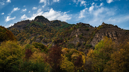 Bright autumn in mountains and blue sky