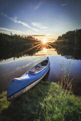 canoe on lake and sunset