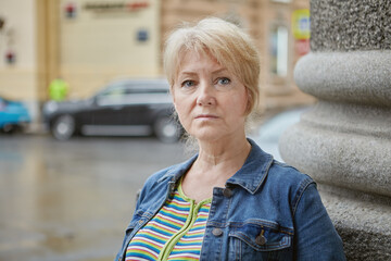 Portrait of a serious senior white woman on street.