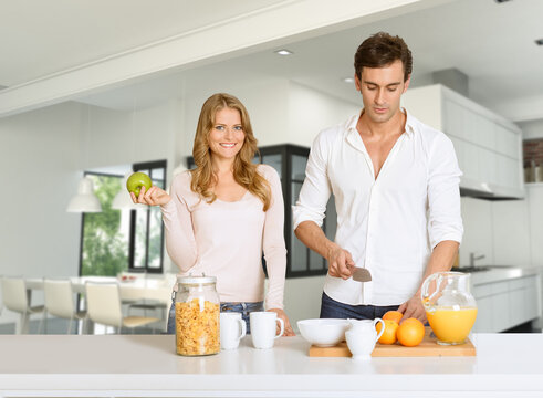 Couple prepairing healthy breakfast in modern interior