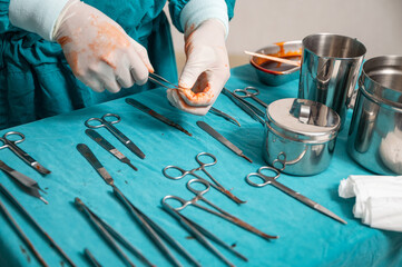 Fototapeta na wymiar Surgeon hand wear medical gloves choosing surgical instruments on a table in operating room