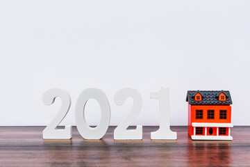 Number 2021 and house model - finance and business concept