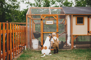 Toddler and Dog Looking at Backyard Chicken Coop
