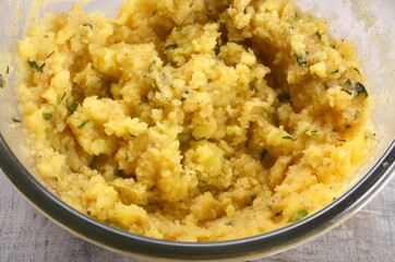 Mashed potato with hot butter and persil on bowl. Classic French potato recipe