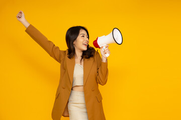 Asian business woman holding megaphone isolated on yellow background, Speech and announce concept