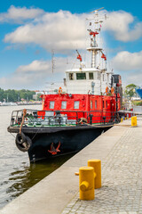 Fireboat or firefighter ship equipped with multiple water cannons and extinguishers. Anchored on...