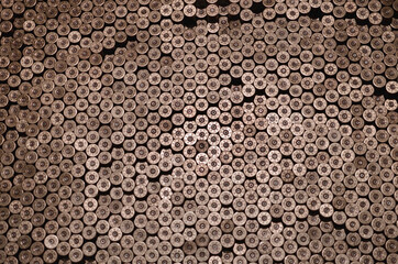 Pattern of 12 gauge cartridges for shotgun bullets. Shells for hunting rifle close up. Backdrop for...
