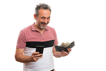 Male presenting wallet with money and smartphone smiling