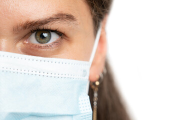 Half face close-up woman wearing protection mask with copyspace