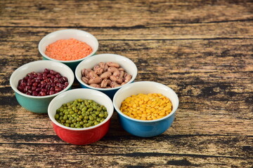 Assorted Legumes: beans and lentils variety on wooden background