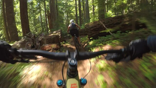 Action Cam Handlebar View of People Mountain Biking on Forest Trail