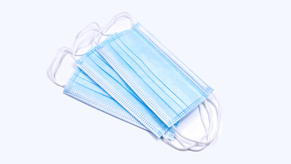 Three anti-bacterial masks overlap on a white background, concept of equipment used to prevent COVID-19.