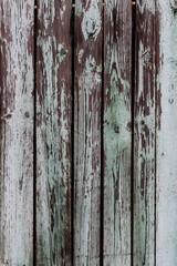 Background and texture of old wooden fence with faded green paint