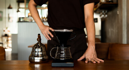 The barista is making coffee by dripping.