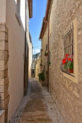 A narrow street among the old stone houses of Castro dei Volsci, a medieval village in the province of Frosinone in Italy.