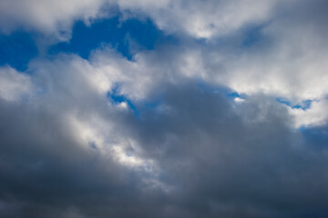 Rain clouds in a blue sky in bright sunlight in autumn, Almere, Flevoland, The Netherlands, October 26, 2020