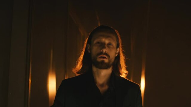 long hair man with beard confidently walks forward