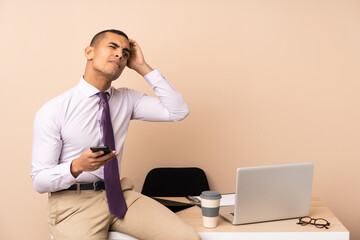 Young business man in a office having doubts and with confuse face expression