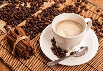 cup of coffee with froth on a bamboo napkin still life