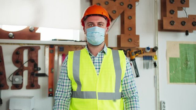 Portrait Of Man Warehouse Worker And Engineer Under Inspection And Checking Production Process On Factory Station, Male Wearing Safety Mask To Protect Coronavirus Covid 19 In Factory.