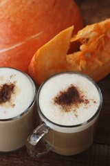 Pumpkin latte on a wooden table macro 