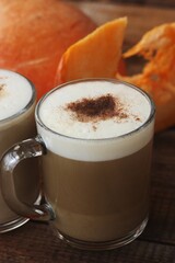 Pumpkin latte on a wooden table macro 