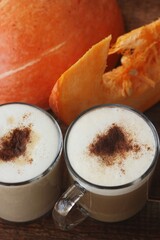 Pumpkin latte on a wooden table macro 