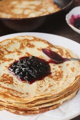 Delicious crepe and blackcurrant jam close up