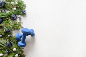 Sport Christmas frame with blue dumbbells, holiday baubles on white background. Greeting card for fitness club with copy space.