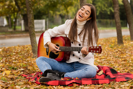 Female street musician portrait, fall scene