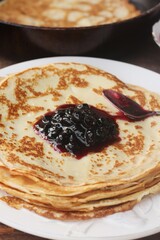 Delicious crepe and blackcurrant jam close up