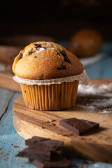 
Fresh cupcake and chocolate on wooden table