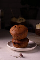 Chocolate muffins with cherry on the plate