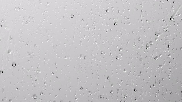rain drops falling on transparent glass