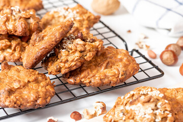Homemade oat cookies with various nuts and sesame seeds close-up. Tasty and healthy dessert,...