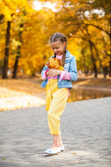 Happy little girl in an autumn park