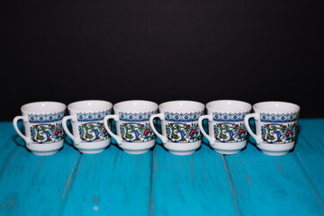 porcelain cup, Turkish coffee cup and blue color background
