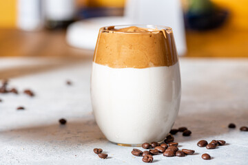 Iced dalgona coffee closeup.  Fluffy creamy whipped trend drink with coffee foam and milk. Korean coffee drink with milk.