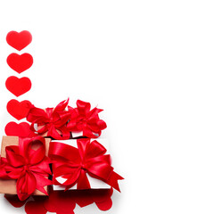 Valentine day composition : many gift boxes with red bows on a white background with hearts. Top View.