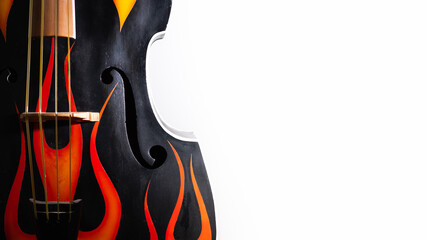 Deck of an acoustic double bass with flames decals. Rock'n'roll, rockabilly musical instrument in...