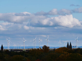 Fototapeta na wymiar wind turbines in the sunshine under clouds