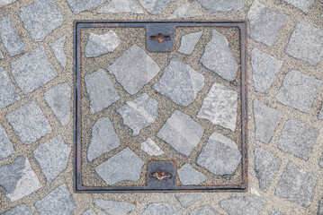 square sewer manhole decorated with stone in Ljubljana Slovenia