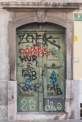 Doors of an old house in Slovenia painted by graffiti