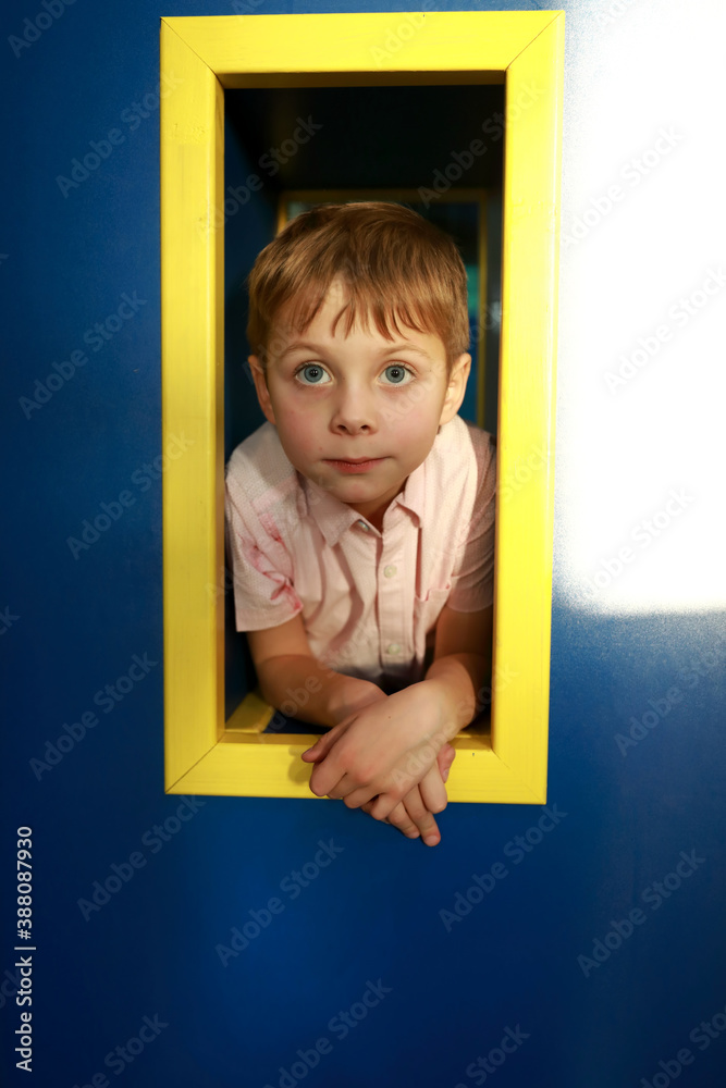 Wall mural Child in rectangular hole in playground