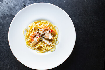 spaghetti seafood pasta shrimp, mussels, squid and more second course top view copy space for text food background rustic